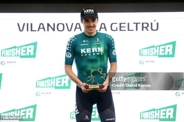 Urko Berrade Fernandez of Spain and Team Equipo Kern Pharma celebrates winning the trophy for the most combative rider on the podium ceremony after...