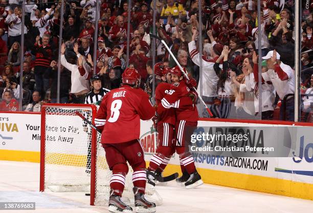 Boyd Gordon of the Phoenix Coyotes celebrates with Keith Yandle and Gilbert Brule after Gordon scored a first period goal against the Chicago...
