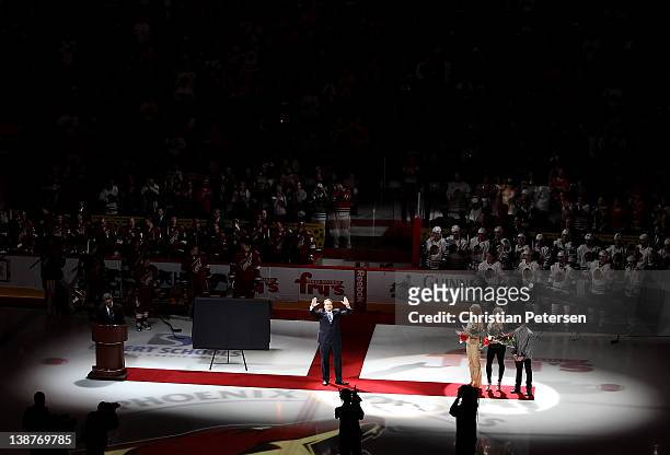 Jeremy Roenick waves to the crowd as he is inducted into the team's Ring of Honor before the NHL game between the Chicago Blackhawks and the Phoenix...
