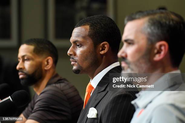 Quarterback Deshaun Watson of the Cleveland Browns speaks while sitting between general manager Andrew Berry and head coach Kevin Stefanski during a...