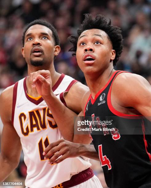 Scottie Barnes of the Toronto Raptors and Evan Mobley of the Cleveland Cavaliers battle for a rebound during the first half of their basketball game...