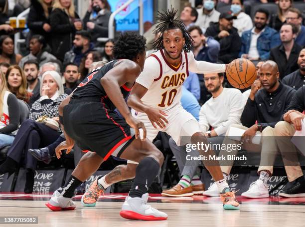 Darius Garland of the Cleveland Cavaliers drives against OG Anunoby of the Toronto Raptors during the first half of their basketball game at the...