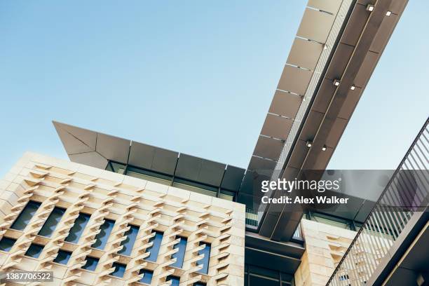 modern stone building and bridge connecting parliament house (dar il-parlament) in valletta, malta. - modern malta stock pictures, royalty-free photos & images