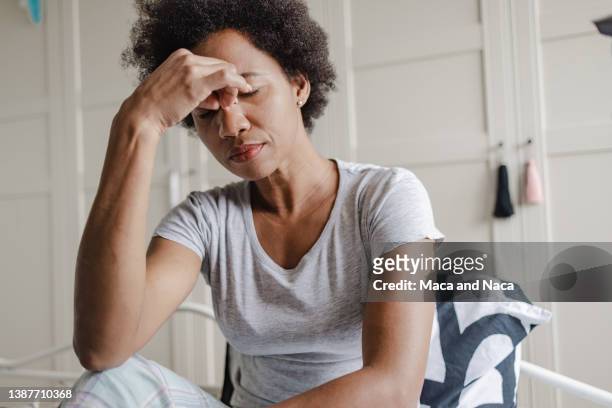 unhappy african-american woman suffering from depression - tired stockfoto's en -beelden