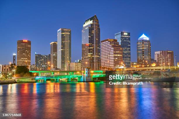 tampa city skyline and bridges during sunset along the hillsborough river in florida usa - tampa sunset stock pictures, royalty-free photos & images