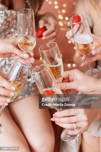 beautiful young women's hands hold glasses of champagne. women's party - glitter fruit stock pictures, royalty-free photos & images