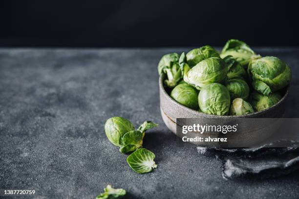 fresh green brussels sprouts in bowl - brussels sprout stock pictures, royalty-free photos & images
