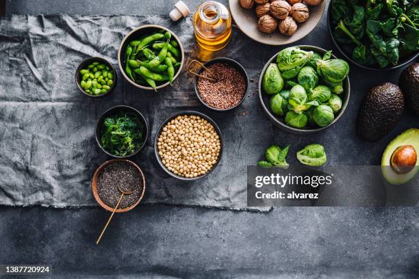 tabletop view of healthy omega 3 vegan food on black counter - chia seed oil stock pictures, royalty-free photos & images