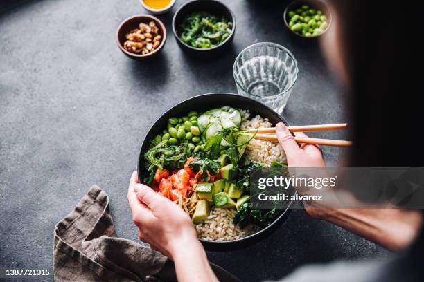 close-up of woman eating healthy salad - dietary fiber stock pictures, royalty-free photos & images