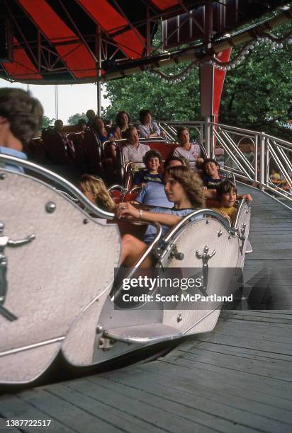 View of park-goers seated in roller coaster cars at Six Flags Great Adventure, Jackson, New Jersey, July 1981.