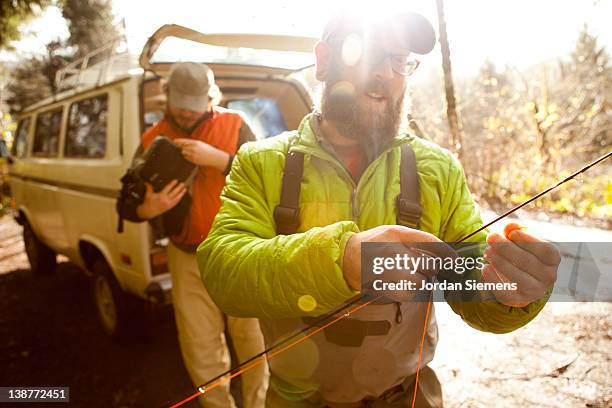 two men fly fishing. - rod stock pictures, royalty-free photos & images