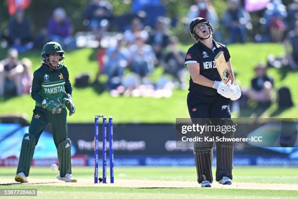 Sophie Devine of New Zealand reacts after being bowled out by Anam Amin of Pakistan as Sidra Nawaz of Pakistan celebrates during the 2022 ICC Women's...