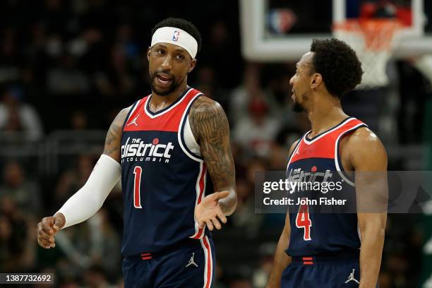 Kentavious Caldwell-Pope talks with Ish Smith of the Washington Wizards during the second half of the game against the Milwaukee Bucks at Fiserv...