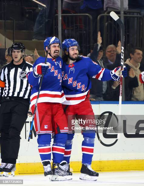 Chris Kreider of the New York Rangers celebrates his goal at 3:58 of the first period against the Pittsburgh Penguins and is joined by Mika Zibanejad...