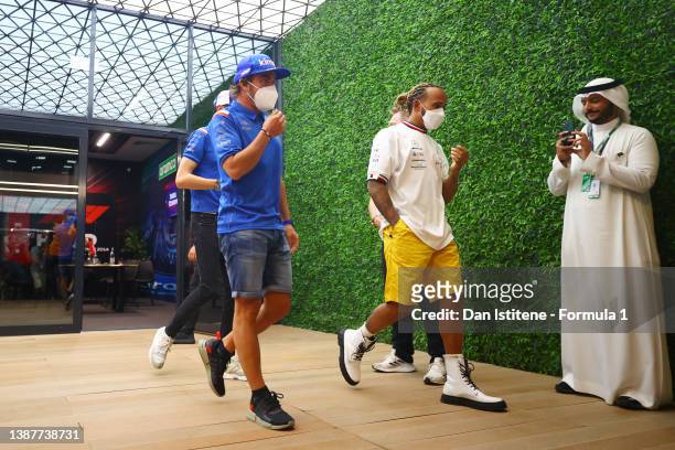 Lewis Hamilton of Great Britain and Mercedes, Fernando Alonso of Spain and Alpine F1 and Esteban Ocon of France and Alpine F1 leave a meeting...