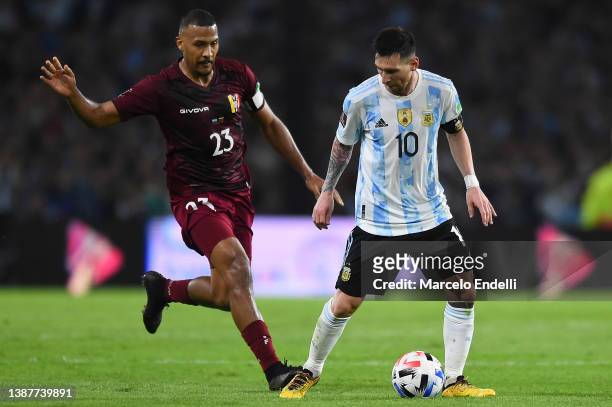 Lionel Messi of Argentina fights for the ball with Salomón Rondón of Venezuela during the FIFA World Cup Qatar 2022 qualification match between...