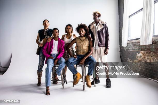 studio portrait of fashionable young adults - vit jacka bildbanksfoton och bilder