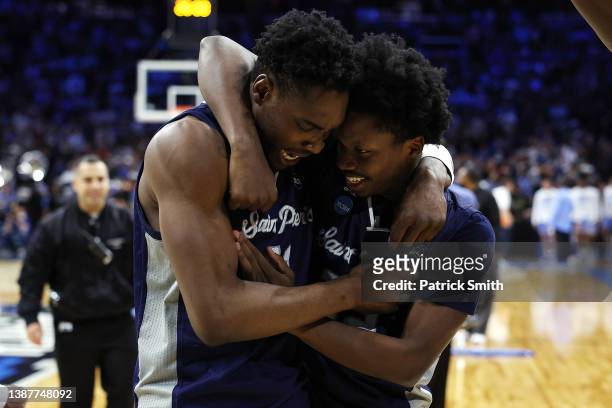 Ndefo and Jaylen Murray of the St. Peter's Peacocks celebrate after defeating the Purdue Boilermakers 67-64 in the Sweet Sixteen round game of the...