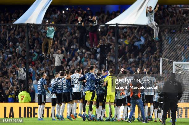 Players of Argentina celebrate with fans after winning the FIFA World Cup Qatar 2022 qualification match between Argentina and Venezuela at Estadio...