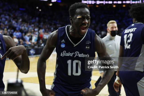 Fousseyni Drame of the St. Peter's Peacocks celebrates after defeating the Purdue Boilermakers 67-64 in the Sweet Sixteen round game of the 2022 NCAA...