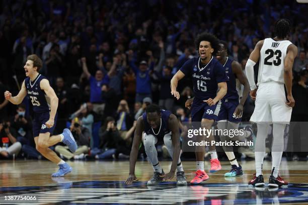 St. Peter's Peacocks players celebrate after defeating the Purdue Boilermakers 67-64 in the Sweet Sixteen round game of the 2022 NCAA Men's...