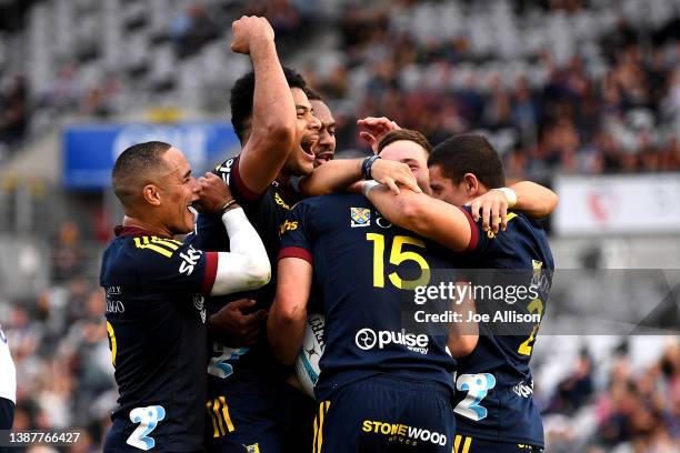 The Highlanders celebrate a try scored by Sam Gilbert during the round six Super Rugby Pacific match between the Highlanders and the Blues at Forsyth...