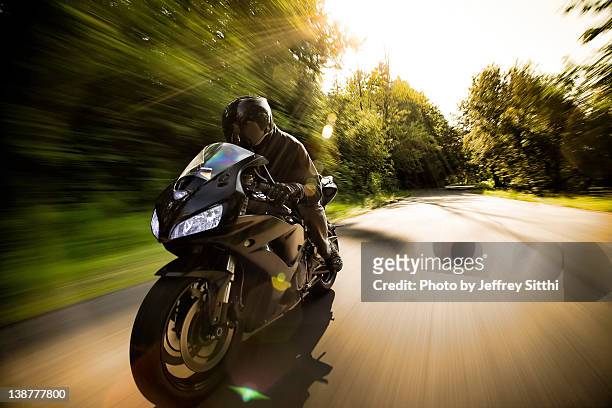 man on motorcycle - riding hat stock-fotos und bilder