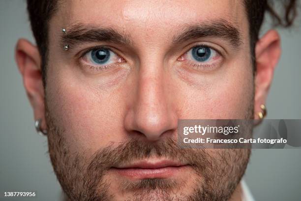 close up  of a man's face - earring stud stock pictures, royalty-free photos & images