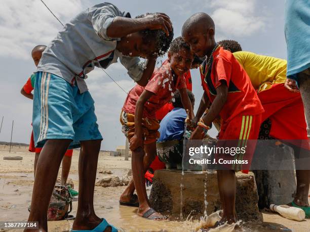 Children from the internally displaced community of Abala wash and drink at a water pump at the Afdera High School on March 25, 2022 in Afdera,...