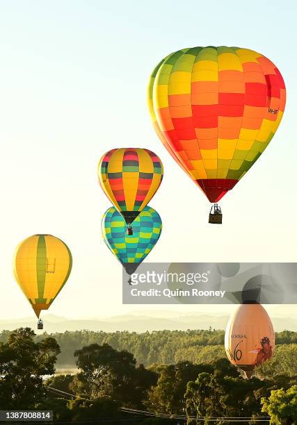 Hot Air Balloons take flight from Brown Brothers Milawa Airfield on March 26, 2022 in Wangaratta, Australia. The King Valley Balloon Fiesta runs from...