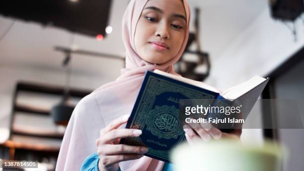 asian woman reading the quran - fajrul islam stock pictures, royalty-free photos & images