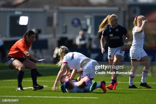 Rosie Galligan of England and Chloe Rollie of Scotland battle as referee Joy Neville goes in between during the TikTok Women's Six Nations match...