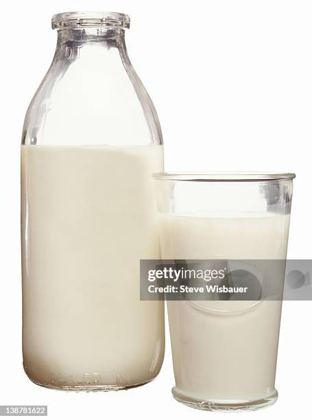 a glass and quart bottle of milk - milk bottle photos et images de collection