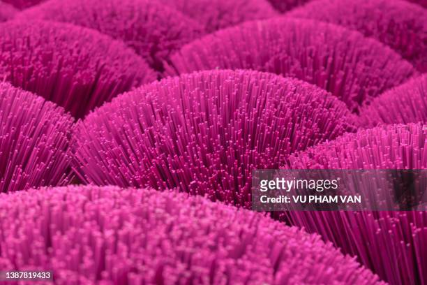 bundles of pink bamboo sticks for incense making - installation art stock-fotos und bilder