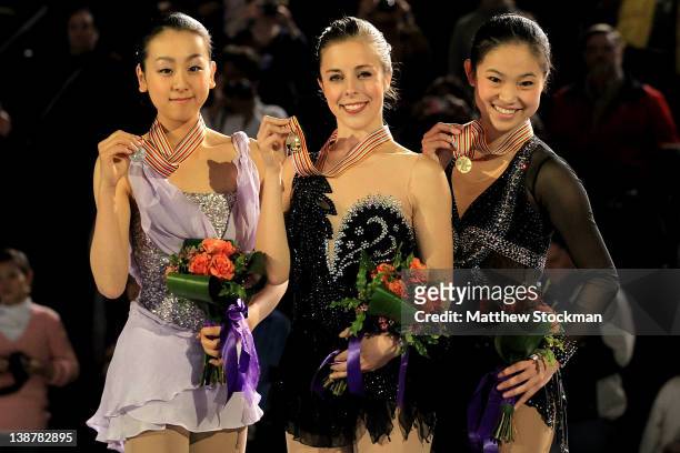 Mao Asada of Japan, Ashley Wagner and Caroline Zhang pose for photographers on the victory podium after the Ladies Competition during the ISU Four...