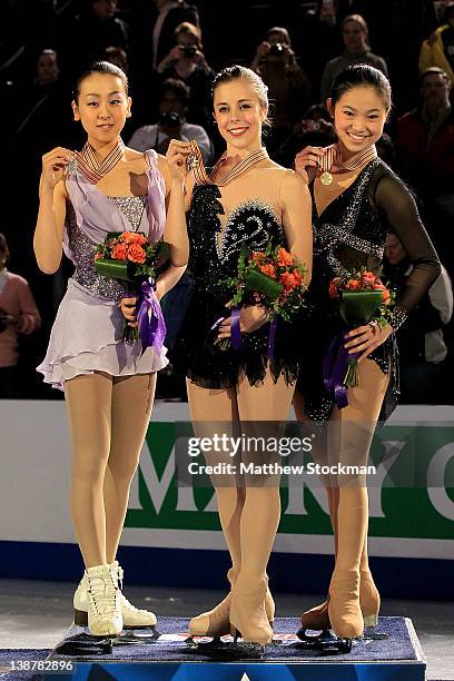 Mao Asada of Japan, Ashley Wagner and Caroline Zhang pose for photographers on the victory podium after the Ladies Competition during the ISU Four...