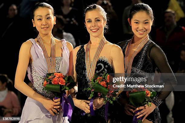 Mao Asada of Japan, Ashley Wagner and Caroline Zhang pose for photographers on the victory podium after the Ladies Competition during the ISU Four...