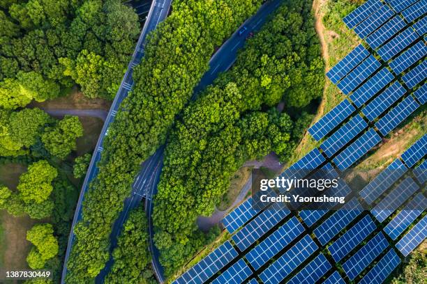 high angle view of solar panels , agricultural landscape - clean energy foto e immagini stock