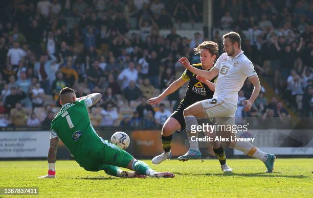 James Wilson of Port Vale scores the opening goal past Dean Bouzanis of Sutton United during the Sky Bet League Two match between Port Vale and...