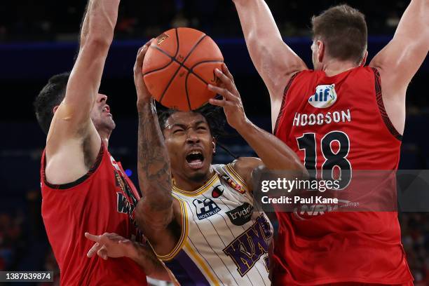 Jaylen Adams of the Kings goes to the basket against Todd Blanchfield and Matthew Hodgson of the Wildcats during the round 17 NBL match between the...