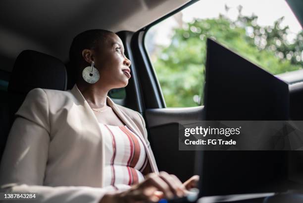 businesswoman looking through window in a car - taxi worried bildbanksfoton och bilder