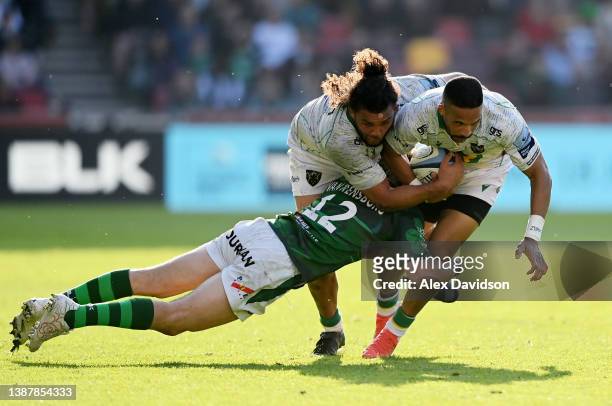 Courtnall Skosan of Northampton Saints is tackled by Benhard van Rensburg of London Irish helped Lewis Ludlam during the Gallagher Premiership Rugby...