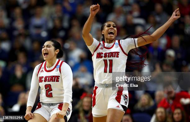 Raina Perez and Jakia Brown-Turner of the NC State Wolfpack celebrate the win over the Notre Dame Fighting Irish during the Sweet Sixteen round of...