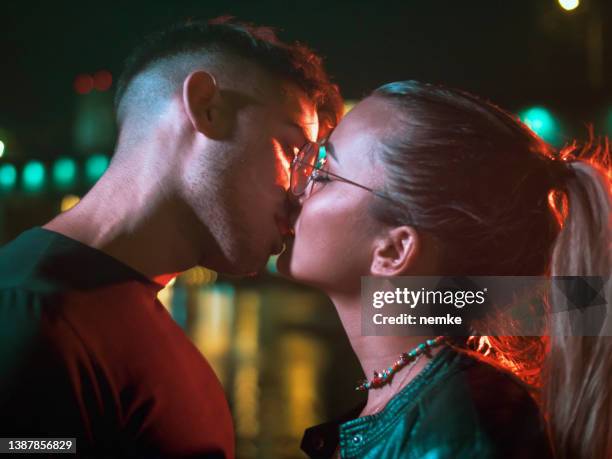apasionada pareja joven que sale por la noche - beso en la boca fotografías e imágenes de stock