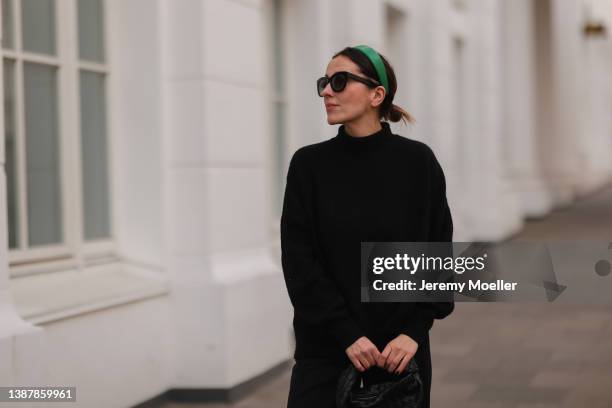 Elise Seitz is seen wearing a Rotate green hairband, Birkenstock beige leather shoes, Victoria Geiser black wide pants, Samsoe Samsoe black knit...