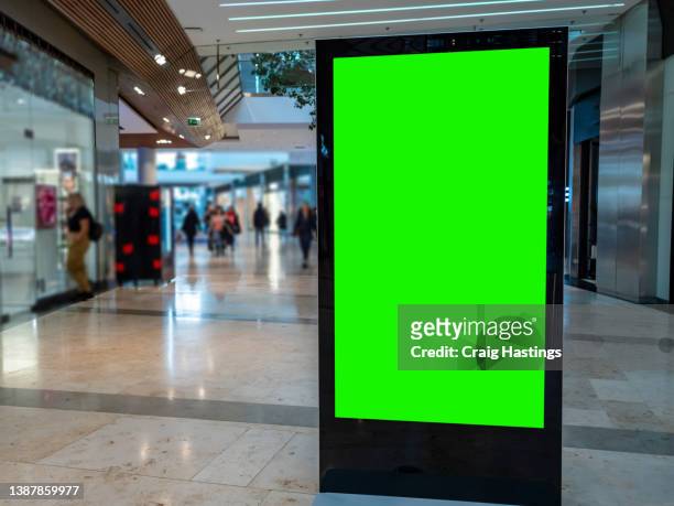 european city centre shopping mall and retail high street with advertising billboard and commercial marketing green screen. chromakey with copy space for marketing to shopping, consumerism and tourism. - shopping centre screen stock pictures, royalty-free photos & images