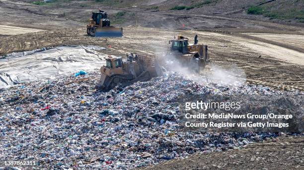 San Juan Capistrano, CA Trash is flattened and spread out across a hilllside before being covered with dirt at the Prima Deshecha landfill in San...