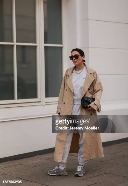 Elise Seitz is seen wearing Yves Saint Laurent black leather bag, Hey Soho grey matching jogging suit with matching sweater and pants, beige...