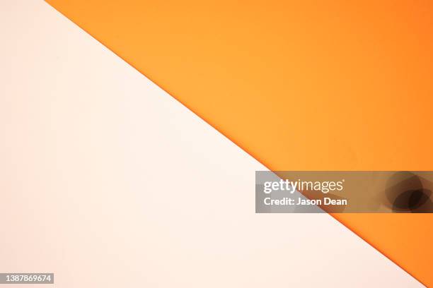 orange and white background - color blocking stock pictures, royalty-free photos & images