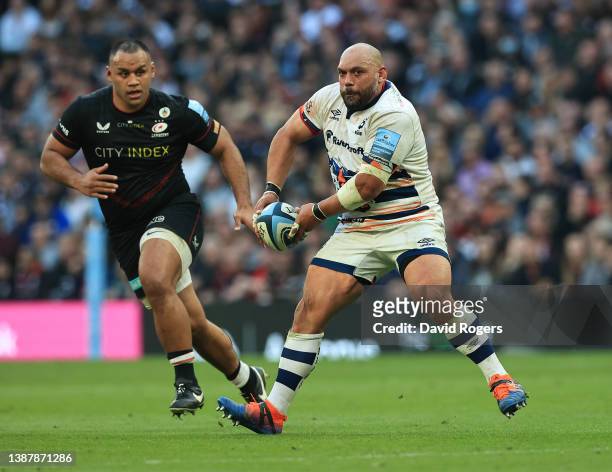 John Afoa of Bristol Bears passes the ball watched by Billy Vunipola during the Gallagher Premiership Rugby match between Saracens and Bristol Bears...